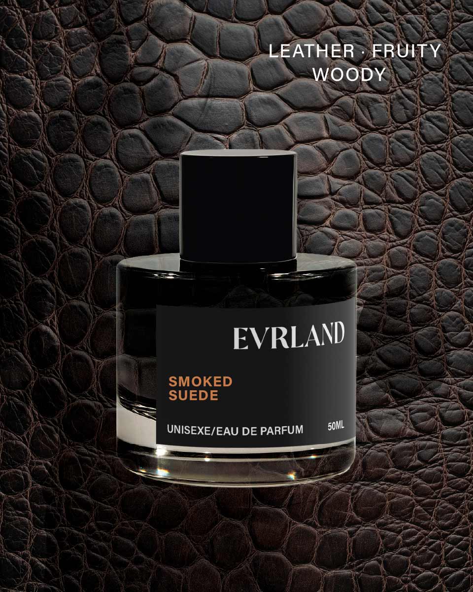 Perfume bottle labeled 'Evrland Smoked Suede' on a textured brown leather background