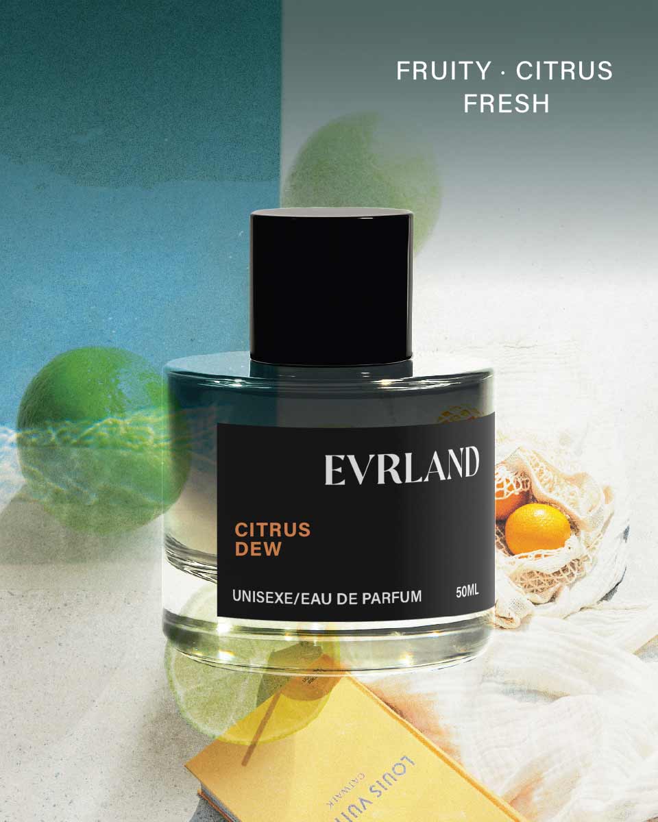 Evrland Citrus Dew perfume bottle with citrus fruits in the background