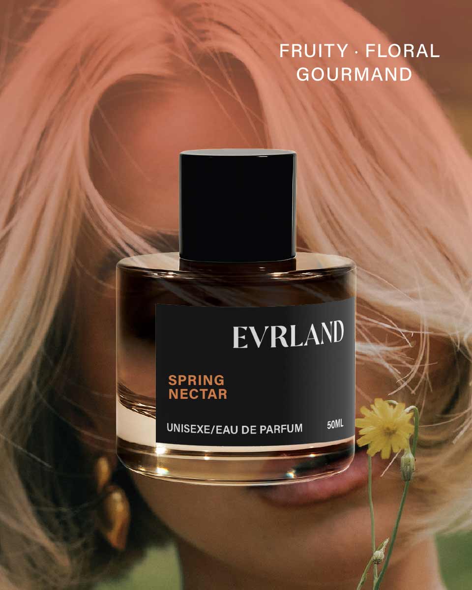 Perfume bottle labeled 'Evrland Spring Nectar' with a blurred background of blonde hair and a yellow flower.