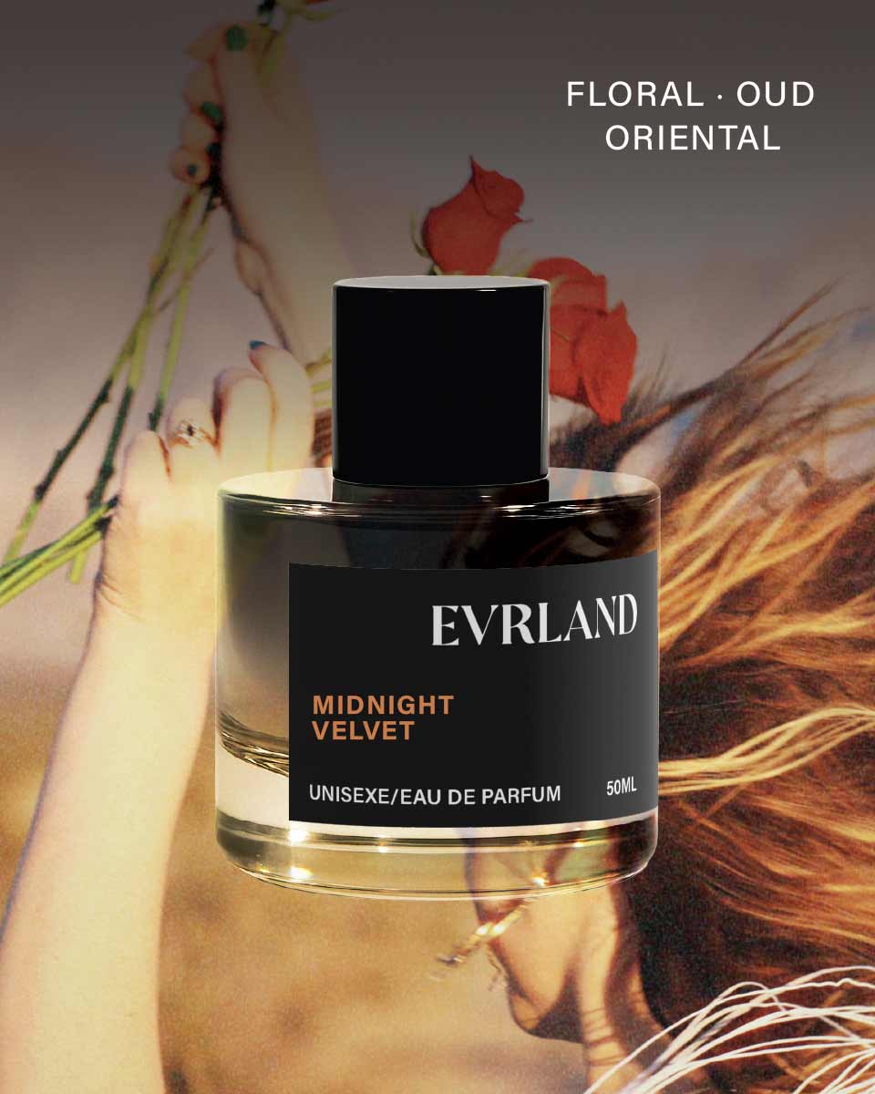 Evrland Midnight Velvet perfume bottle with a blurred background of a person holding flowers.