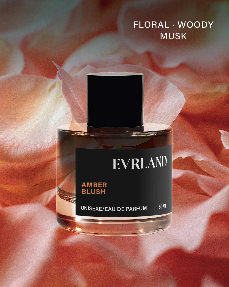 Perfume bottle labeled 'Evrland Amber Blush' on a floral background