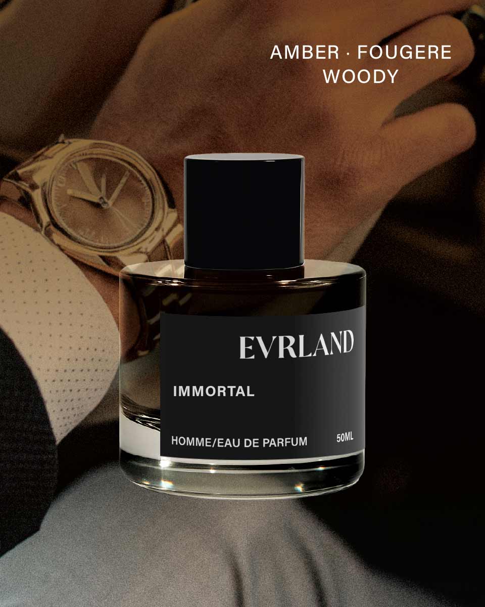 Evrland Immortal perfume bottle with a person wearing a watch in the background