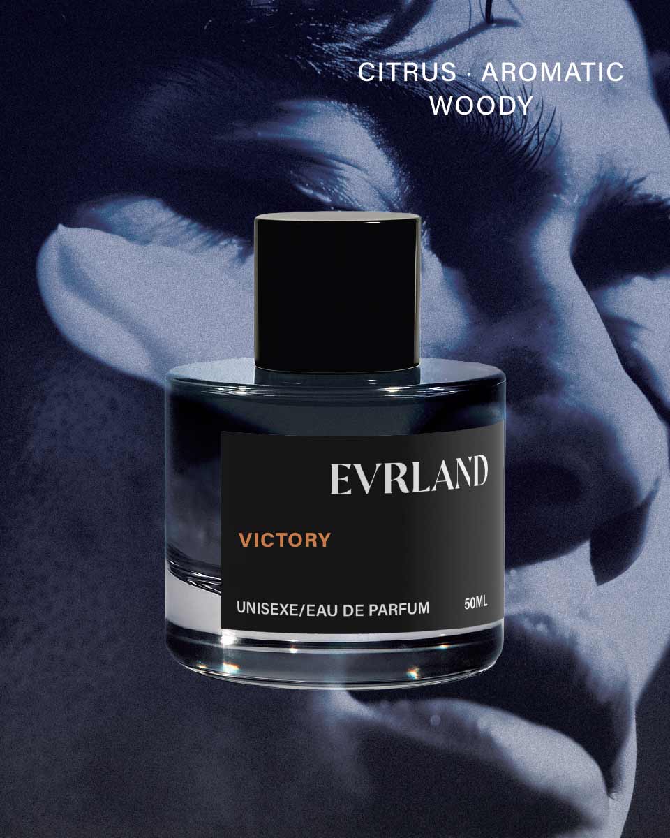 Perfume bottle labeled 'Evrland Victory' with a blurred face in the background